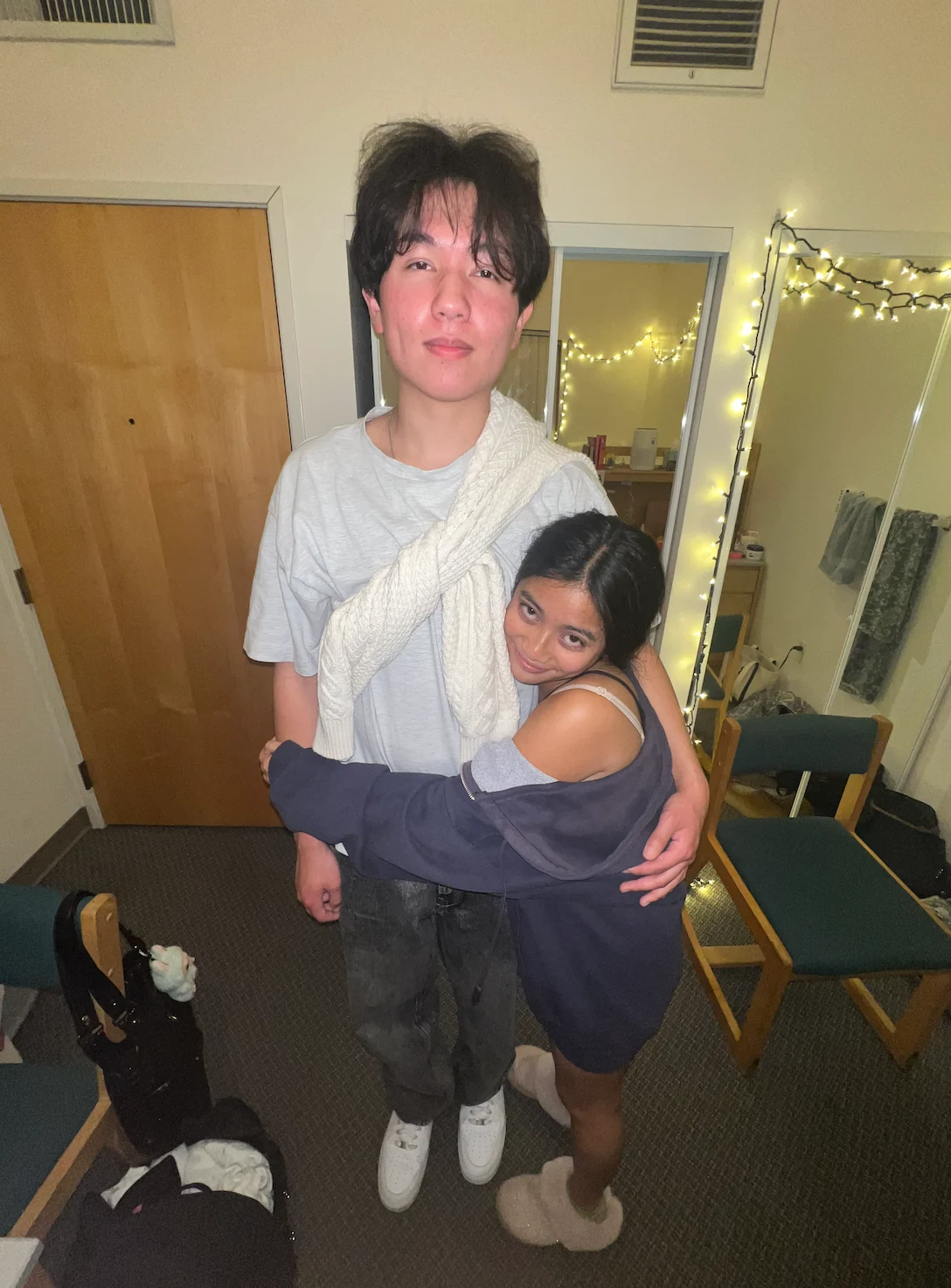 Our first photo together, Bethany hugging Petar beneath string lights